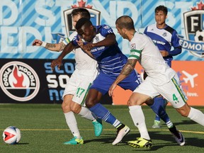 Edmonton's Tomi Ameobi (18) battles New York defenders during NASL soccer play between FC Edmonton and the New York Cosmos at Clarke Stadium in Edmonton, on Wednesday, July 27, 2016.