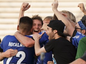 Edmonton's Daryl Fordyce (second from left) celebrates his game-winning goal with fans and players during NASL soccer play between FC Edmonton and the New York Cosmos at Clarke Stadium in Edmonton, on Wednesday, July 27, 2016