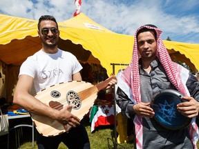 Syrian refugees (from left) Rani and Basel Abou Hamrah pose with cultural instruments during the 2016 Heritage Festival in Hawrelak Park in Edmonton, Alta., on Saturday, July 30, 2016.