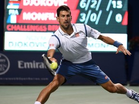 Novak Djokovic, of Serbia, returns a shot from Gael Monfils, of France, in men's semifinal Rogers Cup tennis action, in Toronto on Saturday, July 30, 2016. (Jon Blacker/The Canadian Press)