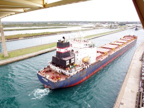 The freighter the Algoma Guardian passes through the Soo Locks under the International Bridge between Sault Ste. Marie, Ont. and Sault, Mich.,in September 2012.