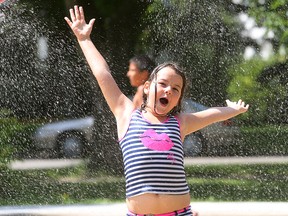 Seven-year-old Alexys Tetrault cools off at a spray park in Winnipeg, Man. Sunday July 31, 2016 as temperatures hit 30C. Brian Donogh/Winnipeg Sun/Postmedia Network