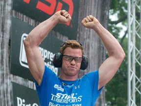 Stirling Hart, of Vancouver, throws his arms in the air in celebration after making two clean cuts with his chainsaw in the hot saw contest at the Stihl Timbersports Canadian Championship in Victoria Park in London, Ont. on Sunday July 31, 2016. Hart was named Canadian Champion following four days of competition.  Craig Glover/The London Free Press/Postmedia Network