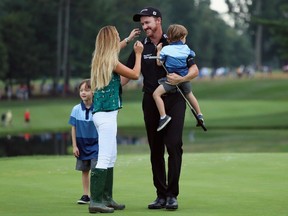 Jimmy Walker celebrates with his wife Erin and sons Beckett and Mclain after making par on the 18th hole to win the PGA Championship at Baltusrol Golf Club in Springfield, N.J., on July 31, 2016. (Andrew Redington/Getty Images)