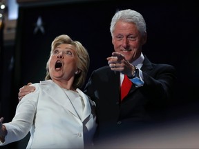 Democratic presidential nominee Hillary Clinton and Former President Bill Clinton react as balloons fall during the final day of the Democratic National Convention in Philadelphia, Thursday, July 28, 2016. (AP Photo/Carolyn Kaster)