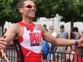 Jordan Monnink of Ottawa places first in the men's long course at the 33rd annual K-Town Triathlon on Sunday, July 31, 2016. Monnink crossed the finish line in front of City Hall in two hours 45 minutes 52 seconds. Steph Crosier/Kingston Whig-Standard/Postmedia Network