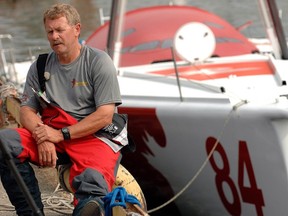 Derek Hatfield sits near The Spirit of Canada, a 60 foot single-handed high performance sailboat after completing it's roll-test for the first time in Toronto, Tuesday June 19, 2007. (CP PHOTO/Aaron Harris)