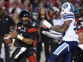 Ottawa Redblacks’ Henry Burris (1) keeps the ball away from Toronto Argonauts’ T.J. Heath (23) during CFL action in Ottawa on Sunday, July 31, 2016. (THE CANADIAN PRESS/Justin Tang)