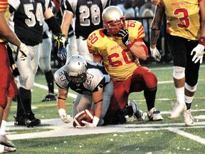 Spartans' Scott Smith is tackled by an Imperials player. Keith Dempsey/For The Sudbury Star