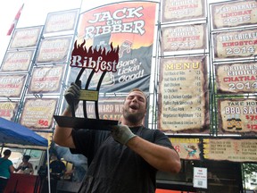 Nathan Di Loreto of Jack The Ribber hoists the Judge?s Choice award for best ribs Monday at Ribfest in Victoria Park.  (CRAIG GLOVER, The London Free Press)