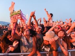 In this Sunday, July 31, 2016, photo, people attend the HARD Summer Music Festival at the Auto Club Speedway in Fontana, Calif. Authorities say multiple people died after attending the weekend rave. (John Valenzuela/The Sun via AP)