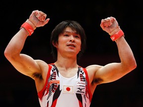 Japan’s Kohei Uchimura celebrates on the horizontal bar during the men's apparatus final competition at the World Artistic Gymnastics championships at the SSE Hydro Arena in Glasgow, Scotland, in this Nov. 1, 2015 file photo. (AP Photo/Matthias Schrader)