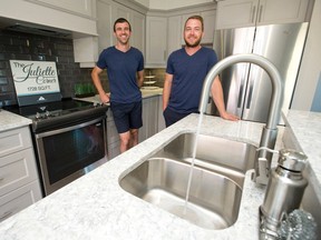 Mike Carruthers, left, and Mike Cameron of Tru Homes stand in a show house kitchen with plumbing the contractors installed on Shore Drive in London. (CRAIG GLOVER, The London Free Press)