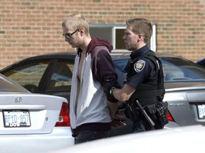 An individual is taken into custody after Ottawa Police were called to 1993 Jasmine Crescent after reports of a gunshot, in Ottawa on Tuesday, August 2, 2016. Police took two people into custody; charges have not been laid against the individuals.