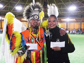 Ironman dance champions Lennon First Rider (Siksika) and Carol Melting Tallow (Santa Fe, NM) pose with their payouts around 1:30 a.m. on Sunday morning.