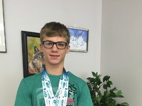 Local swimmer, Nathaniel Patten, poses for a photo wearing the medals he won at the Alberta Summer Games held in Leduc from July 14 to 17.