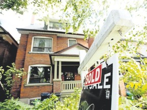 A Toronto house with a sold sign is pictured  in this June 23, 2015 file photo.   (Tyler Anderson/Postmedia Network)