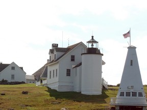 This July 20, 2016 photo shows a lighthouse as seen on a lighthouse tour operated by Monhegan Boat Line out of Port Clyde, Maine. The tour included a demonstration of lobstering by a guide and third-generation lobsterman. (Debbie Galant via AP)