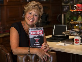 Columnist Sue-Ann Levy holds a copy of her new book, Underdog: Confessions of a Right-Wing Gay Jewish Muckraker. (CRAIG ROBERTSON, Toronto Sun)
