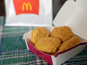 FILE - In this March 4, 2015, file photo, an order of McDonald's Chicken McNuggets is displayed for a photo in Olmsted Falls, Ohio. McDonald’s had signaled changes were in store in late 2014, and the company said it was evaluating the cooking procedures and ingredients for its core menu items. McDonald's said it is testing Chicken McNuggets made without artificial additives and fresh beef instead of frozen beef for some burgers.
