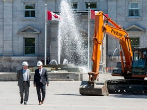 Johnston and National Capital Commission CEO Mark Kristmanson, both wearing white hard hats, emerged from the front entrance of Rideau Hall to speak about the project — the last time the governor general or anyone else will be able to use that entrance until the project is finished. Justin Tang/The Canadian Press