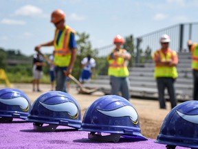 Workers prepare a mound of sand before the groundbreaking ceremony for a Minnesota Vikings facility, Tuesday, Aug. 2, 2016, in Egan, Minn. The Vikings have secured naming rights for their new headquarters, with local physician group and sports medicine provider Twin Cities Orthopedics. (Glen Stubbe/Star Tribune via AP)