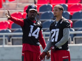 Injured Redblacks defensive back Abdul Kanneh (left) talks with fellow DB Mitchell White during practice at TD Place.