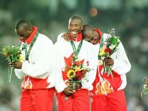 Robert Esmie (right) stands with men's 4x100-metre relay teammates Bruny Surin, Glenroy Gilbert and Donovan Bailey during a medal ceremony at the 1996 Summer Olympic Games in Atlanta. Wednesday marks 20 years since Esmie, a Sudbury-raised sprinter, helped Canada win gold at the event. Canadian Press