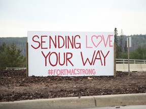 A handmade sign in the middle of the Prairie Loop Boulevard traffic circle near the entrance to the Waterways neighbourhood of Fort McMurray Alta. on June 8, 2016. Olivia Condon/ Fort McMurray Today/ Postmedia Network