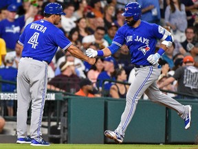 Blue Jays outfielder Jose Bautista, right, shakes hands with third base coach Luis Rivera after hitting a solo home run off Astros starting pitcher Lance McCullers Tuesday, Aug. 2, 2016, in Houston. (AP Photo/Eric Christian Smith)