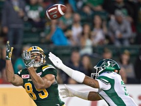 Saskatchewan Roughriders' Justin Cox (31) chases Edmonton Eskimos' Nate Coehoorn (85) as he tries to make the catch during second half action in Edmonton on July 8, 2016.