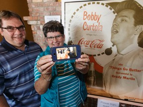 Gary and Diane Gawryliuk show a recent photo of her and singer Bobby Curtola during a celebration of the singer's life at the Ranch Roadhouse in Edmonton, Alberta on Tuesday, August 2, 2016. Gary and his wife Diane drove in from Yorktown, S.K. for the event. Ian Kucerak / Postmedia