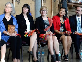 From left, commissioners Marion Buller, Qajaq Robinson, Marilyn Poitras, Michele Audette and Brian Eyolfson listen during the announcement of the inquiry into Murdered and Missing Indigenous Women at the Museum of History in Gatineau, Que., on Wednesday, Aug. 3, 2016. The federal government has announced the terms of a long-awaited inquiry into murdered and missing indigenous women, unveiling that it will need at least $13.8 million more for the study than was originally expected. (THE CANADIAN PRESS/Justin Tang)
