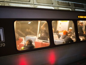 In this photo taken Nov. 16, 2015, passengers ride a Washington Metro subway train at the Chinatown Metro Station in Washington. Authorities say a Washington, D.C.-area transit police officer has been charged in an FBI sting with attempting to support the Islamic State group. Court documents say 36-year-old Nicholas Young of Fairfax was arrested Wednesday morning. (AP Photo/Pablo Martinez Monsivais)