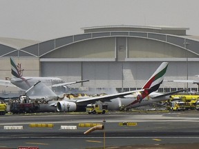 A picture shows a Boeing 777 of the UAE airliner Emirates after it caught fire following a crash-landing at Dubai airport on Aug. 3, 2016. (AHMED RAMZAN/AFP/Getty Images)