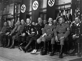 An undated picture shows German Nazi Chancellor Adolf Hitler (1rst row, 2nd R) attending a rally with high rank nazi officials including  Admiral Karl Doenitz (2nd L), Chief of the German Police Heinrich Himmler (5th L), Austrian Nazi leader Arthur Seyss-Inquart and Hitler's Secretary Martin Bormann (R). Other Nazi dignitaries are not identified. (AFP/Getty Images)