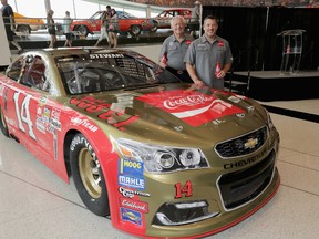 Bobby Allison and Tony Stewart pose for pictures with the car's new paint scheme during the No. 14 Darlington Throwback Announcement True Speed Press Conference at NASCAR Hall of Fame on August 3, 2016 in Charlotte, North Carolina.  (Streeter Lecka/Stewart-Haas Racing via Getty Images)