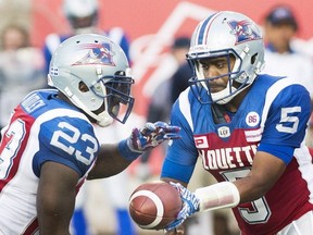Alouettes QB Kevin Glenn (5) hands off to Brandon Rutley during first half CFL action against the Roughriders in Montreal on July 29, 2016. The Alouettes face the Lions on Thursday. (Graham Hughes/The Canadian Press)