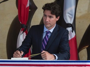 Prime Minister Justin Trudeau pauses as he signs the book of condolence at the French Embassy Monday July 18, 2016 in Ottawa. THE CANADIAN PRESS/Adrian Wyld