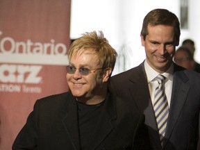 Elton John and Premier Dalton McGuinty arrive at a press conference today at Starz Animation (what later became Arc Productions). (Toronto Sun files)