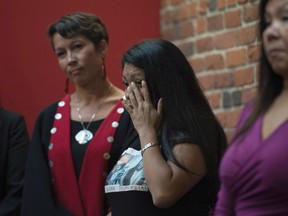 Lorelei Williams wipes a tear from her eye during a news conference on Missing and Murdered Indigenous Women and girls in Vancouver, B.C., Wednesday, August, 3, 2016. THE CANADIAN PRESS/Jonathan Hayward