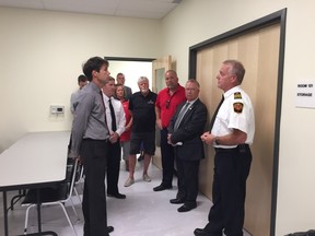 Submiited photo
Prince Edward County Fire Chief Scott Manlow (first) speaks to Health Minister Eric Hoskins, while Mayor Robert Quaiff and MPP Todd Smith look on during the ministers visit to Picton on Tuesday.