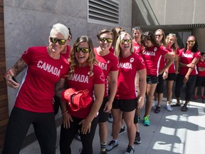 Members of Canada's Women's Rugby Sevens team led by captain Jen Kish, left, pose for a photo before an announcement by Canadian Olympic Committee (COC) and Rugby Canada in Toronto on July 26, 2016, to introduce the players to represent Team Canada at this year's Rio Olympics.