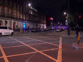 The area where a knife attack happened is cordon off in London Thursday, Aug. 4, 2016. London police say a woman has died and others were injured in a knife attack in a central part of the city. (Sky News via AP)