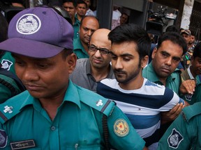 British national Hasnat Karim, centre left, and University of Toronto student Tahmid Hasib Khan, centre right, are taken before court in Dhaka, Bangladesh, Thursday, Aug. 4, 2016. (AP Photo)
