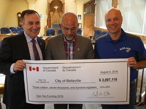 Jason Miller/The Intelligencer
MP Neil Ellis (left) drops off some federal gas tax funds to Mayor Taso Christopher and Coun. Mitch Panciuk. Since the program began a decade ago the City of Belleville has received more than $28 million in funds.