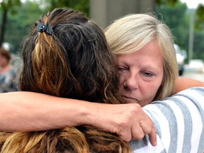 Ginny Peak, right, sister of Garr Keith Hardin embraces a family member following court proceedings, Thursday, Aug. 4, 2016 at the Meade County Courthouse in Brandenburg Ky. A Kentucky judge is considering whether Garr Keith Hardin and Jeffrey Dewayne Clark should be let out of jail after spending more than 20 years in prison before their murder convictions in what prosecutors called a "satanic" killing were vacated.  (AP Photo/Timothy D. Easley)