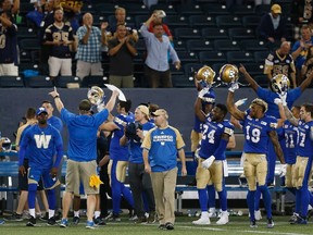 Winnipeg Blue Bombers head coach Mike O'Shea and some players thank the remaining fans at the end of CFL game against the Hamilton Tiger-Cats in Winnipeg Wednesday, August 3, 2016.