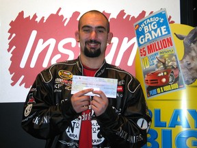 Daniel Carley of St. Catharines, Ont., is pictured collecting his prize after winning $5 million on a lottery scratch ticket. (CNW Group/ Ontario Lottery and Gaming Corporation)