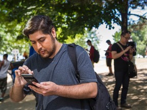 Roberto Vazquez, 24, says he's the first Toronto Pokemon Go player to catch all 142 Pokemon available in North America, found around the Greater Toronto Area. He demonstrates the game on his phone, among the other players, by the Jack Layton Ferry Terminal in Toronto, Ont.  on Thursday August 4, 2016. Ernest Doroszuk/Toronto Sun/Postmedia Network